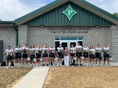 Rotary Club of Jasper President, Dana Callan, with the Pickens County High School Football team and their new backpacks